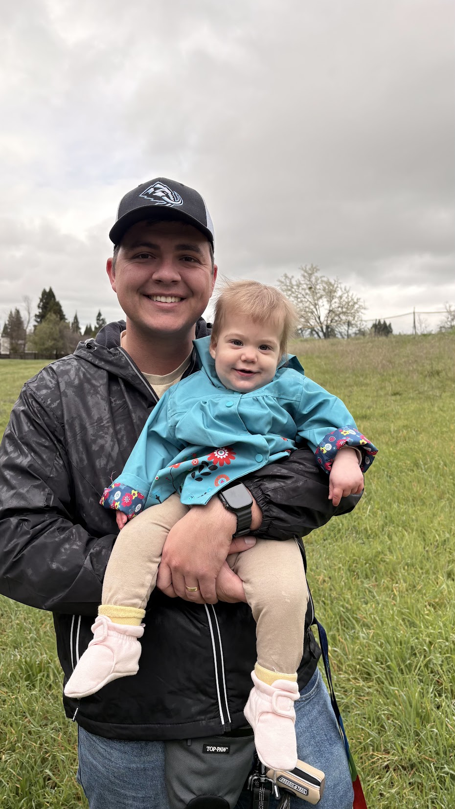 Skyler holding his daughter outdoors