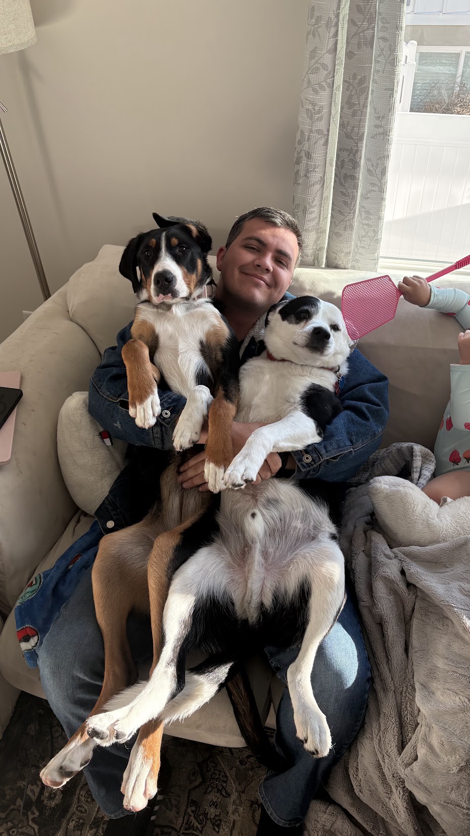 Skyler with two dogs on the couch